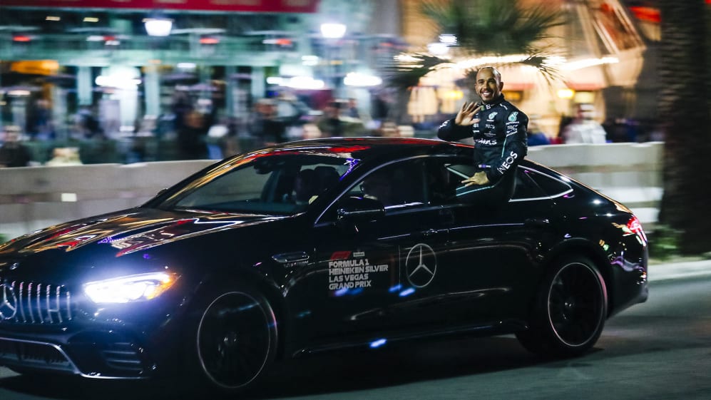 SIR LEWIS HAMILTON SITTING ON THE WINDOW OF A SAFETY CAR