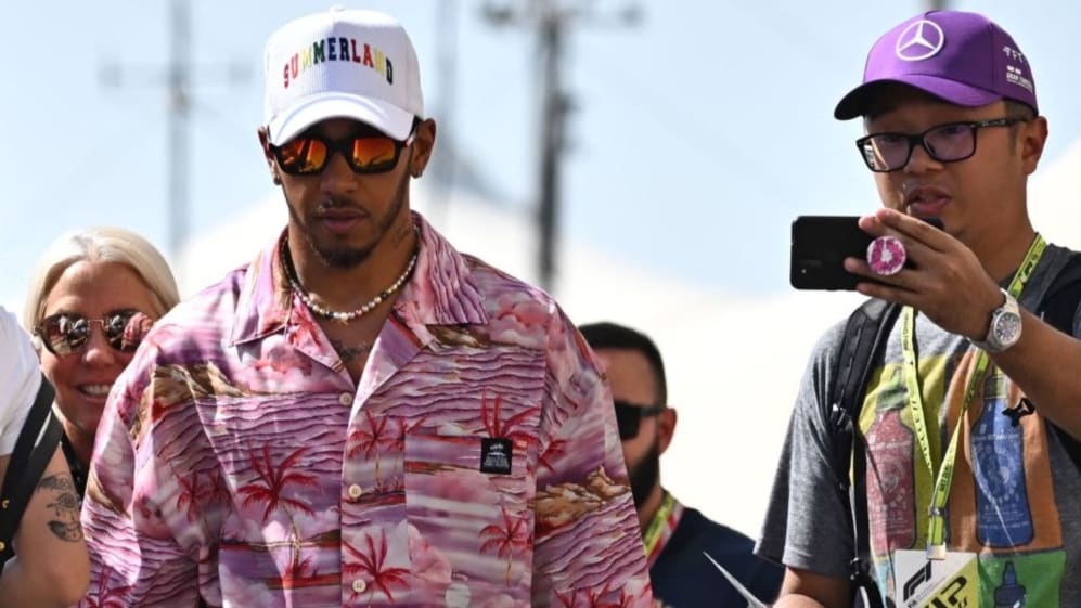 Mercedes' British driver Lewis Hamilton (L) arrives before the first practice session ahead of the Abu Dhabi Formula One Grand Prix at the Yas Marina Circuit in the Emirati city of Abu Dhabi on November 18, 2022. (Photo by Ben Stansall / AFP) (Photo by BEN STANSALL/AFP via Getty Images)