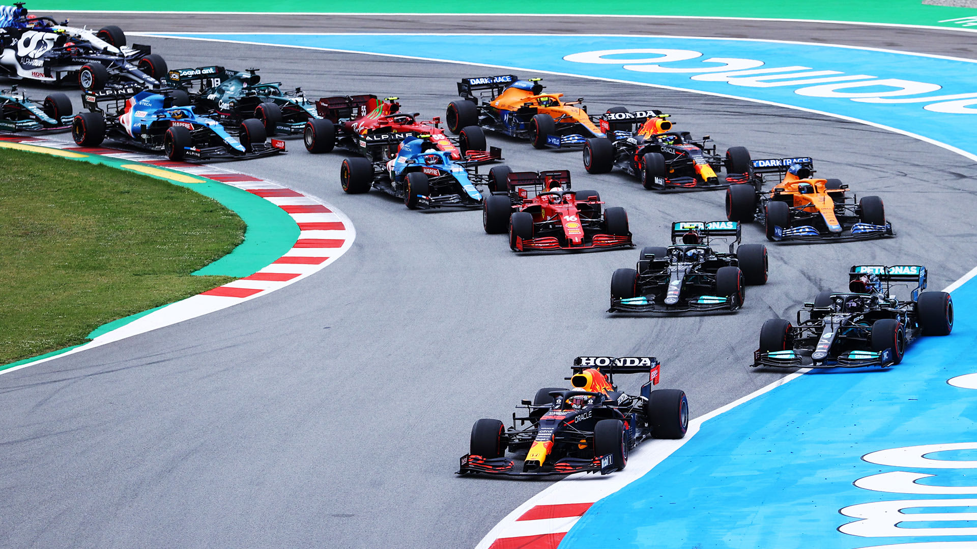 Max Verstappen leads the pack after a first-corner lunge on Lewis Hamilton at the Spanish Grand Prix.