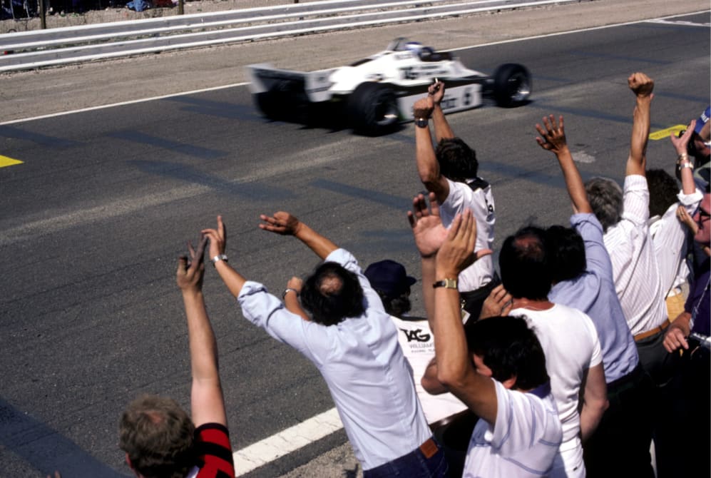 Williams team celebrates as Keke Rosberg (FIN) Williams FW08 crosses the line to claim his first GP win and the only win in his championship winning season